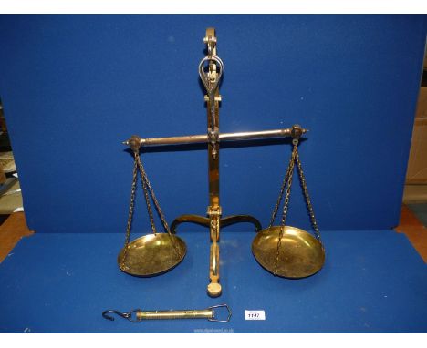 A brass balance scales and small brass spring balance scales.