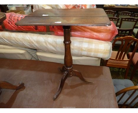 An Oak rectangular topped Occasional Table standing on a turned pillar with three splay feet, 17" x 23".