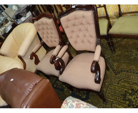 A pair of Mahogany framed open armed button back Chairs standing on turned front legs, the backs, arms and base upholstered i