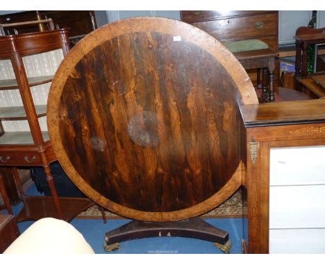 A William IV Mahogany & Rosewood snap-top circular Dining Table having contrasting burrwood banding to the top and raised on 