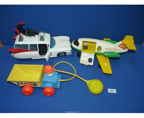 A vintage Ghostbusters toy car and two vintage Fisher Price toys in the form of an aeroplane and a dumper truck.
