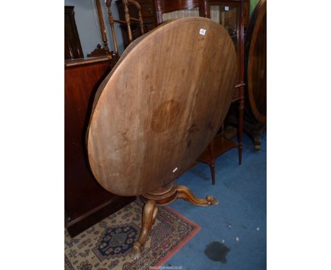 A circular Satinwood snap-top Dining/Centre Table standing on a hexagonal tapering pillar with three splay feet, 41 3/4" diam