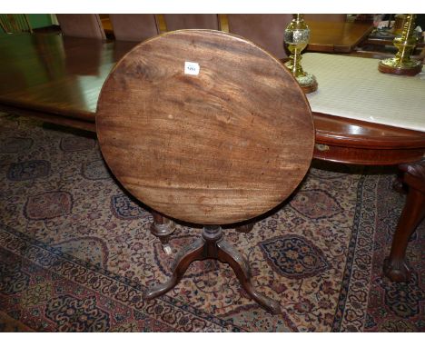 A Mahogany snap-top circular Occasional Table standing on a turned and fluted shaped pillar with three elegant carved detail 