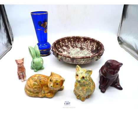 A German pottery bowl, two china cats and one stone cat plus a Sylvac rabbit and a blue glass vase.