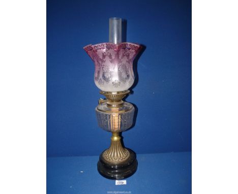A china based Oil Lamp with clear glass reservoir (small crack to top), pink etched and frosted shade and chimney, 21 3/4'' t
