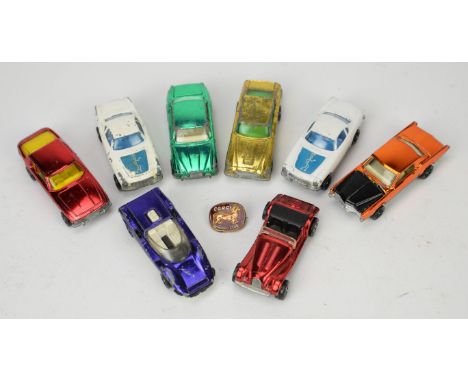Corgi Rockets toy cars. The Saint Volvo, Gold Aston Martin, Morgan, Jensen Interceptor plus a button badge. (9)Condition Repo