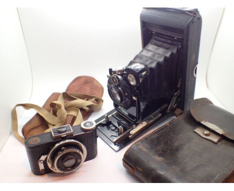 Two vintage cameras with bellows one Ensign model and a German film camera with focusing ring