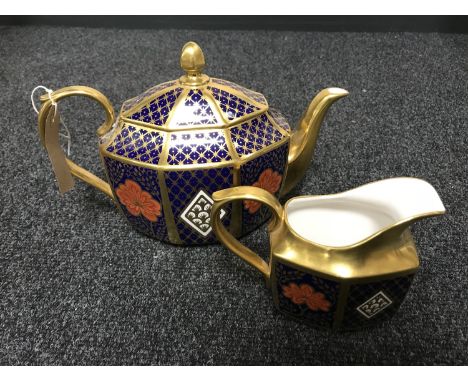 A Caverswall teapot and sugar basin decorated in Romany 22ct gold leaf.