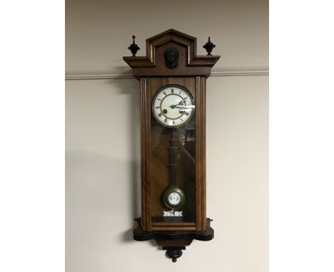 A walnut cased eight day wall clock with enamel dial