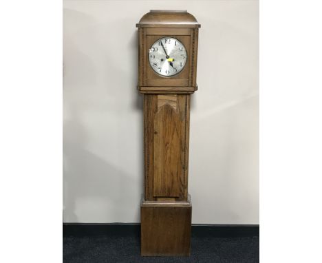 An oak cased granddaughter clock with silvered dial 