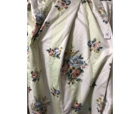 A pair of floral fully lined curtains