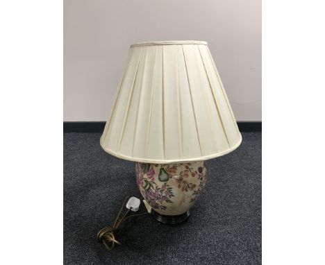 A china table lamp and shade on wooden base with fruit and flower decoration