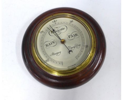 Mahogany framed wall mounted barometer with a circular silvered dial, 20cm 