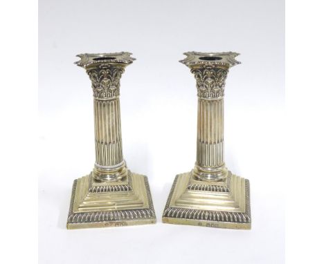 A pair of Victorian silver candlesticks, by William Hutton &amp; Sons, London 1895, corinthian column design with square weig