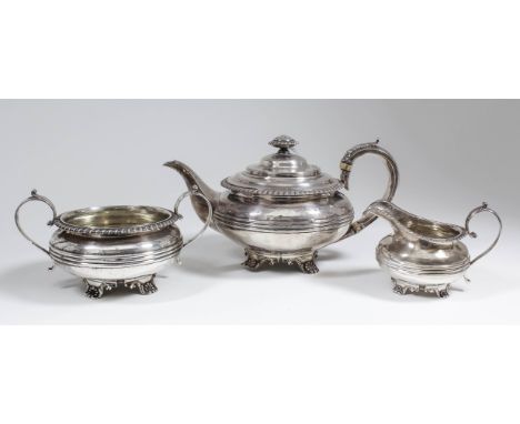 A William IV silver three piece tea service, the squat circular bodies with gadroon mounts to rim and moulded girdles, each o