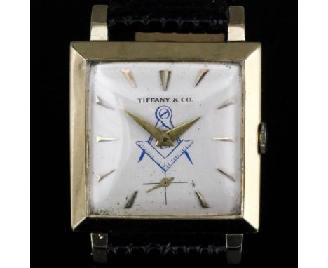 A 1980's gentleman's "Masonic" wristwatch by Tiffany & Co, a gold square case (30mm x 30mm), the silver faced marked "Tiffany