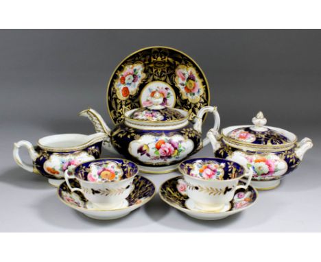 A 19th Century Staffordshire bone china tea service enamelled in colours with floral sprays within shaped gilt reserves on a 