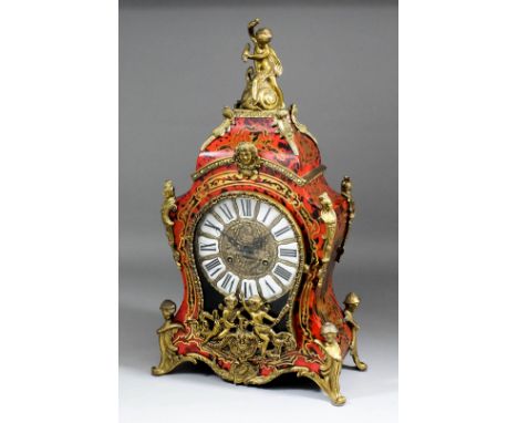 A modern French red Boulle effect and brass mounted mantel clock of 18th Century design, the 6.75ins diameter cast brass dial