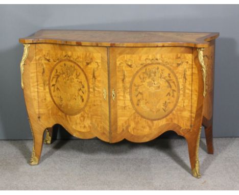 A 20th Century French gilt metal mounted satinwood and kingwood bombe shaped commode of Louis XV design, inlaid with floral m
