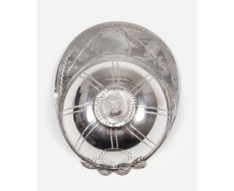 A George III silver "Jockey's Cap" pattern caddy spoon, the top and peak engraved with leaf and floral ornament and vacant sh