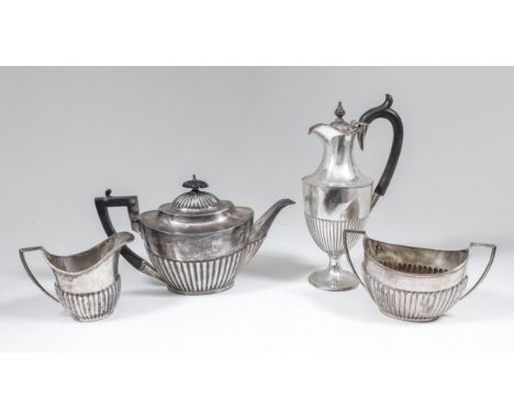 A George V silver Harlequin three piece tea service with oval partly reeded bodies, comprising - teapot, 6.25ins high, Sheffi