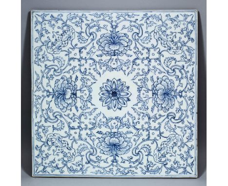 A Chinese blue and white porcelain tile painted with stylised peonies, leaves and bats, 13.5ins (343mm) square (19th Century)