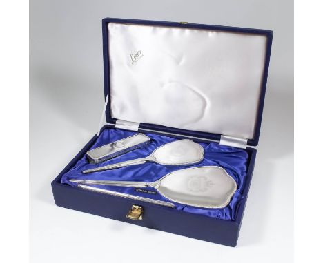 An Elizabeth II lady's silver backed four piece "Jubilee" dressing table set, comprising - cloth brush, hair brush, mirror an