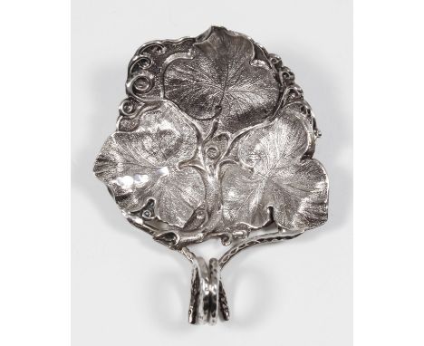 A George III silver leaf pattern caddy spoon, the triangular bowl die stamped with three bold leaves and with scrolled handle