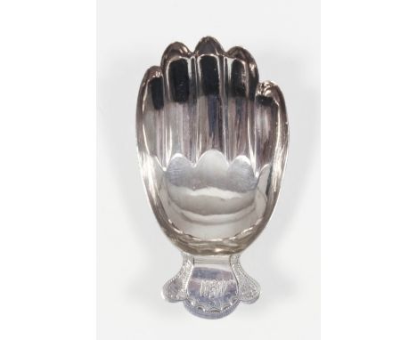 A George III silver "Hand" pattern caddy spoon modelled in the form of a right hand, the shaped handle engraved with swag orn