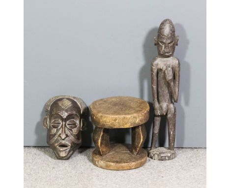 Three African carved and stained wood items - face mask, 10ins x 8ins, stool, 9.5ins x 8.5ins x 10ins high, and standing figu