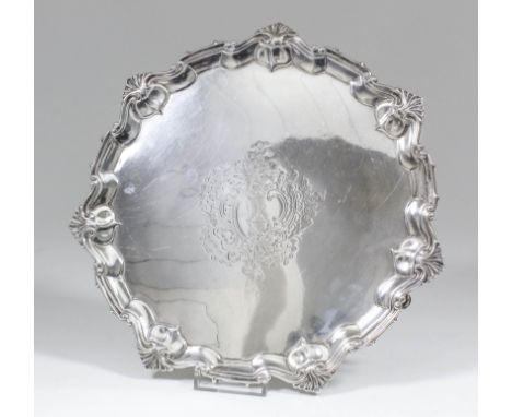 A late Victorian silver circular salver of Georgian design, the moulded rim with C, S and leaf scroll mounts, the centre engr