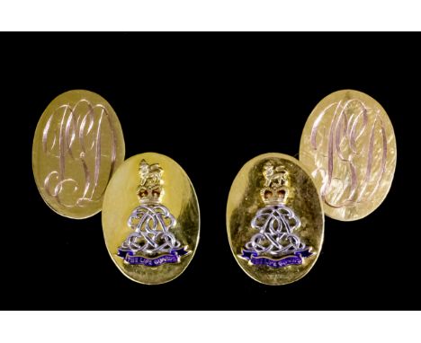 A pair of Elizabeth II gentleman's 9ct gold cufflinks, the oval face with applied white, yellow and blue enamel crest of the 