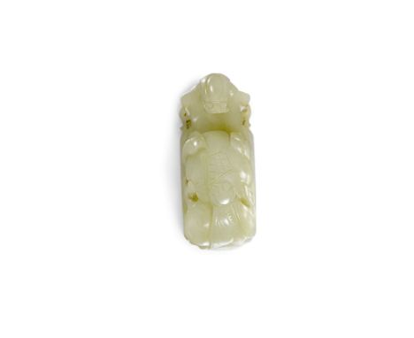 A Chinese celadon jade belt hook, carved with a stylised dragon, fruit and fly, 2ins (50mm) overall (Qing Dynasty - 19th Cent