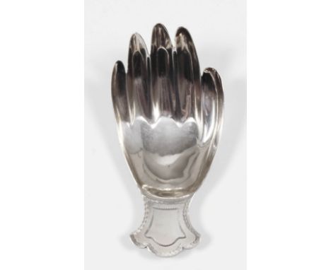 A George III silver "Hand" pattern caddy spoon, the die stamped in the form of a right hand, the shaped terminal with wriggle