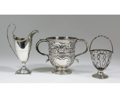 A George III silver helmet pattern cream jug with bead mounts to rim and part fluted body, high scroll handle and on square b