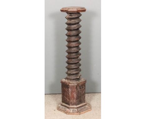 An ebonised wood pedestal with octagonal top, spiral turned centre column and stepped base, 13.5ins square x 44.5ins high (sl