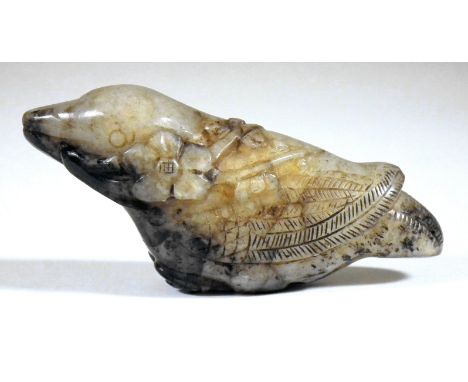 A Chinese black and celadon jade carving of a bird and prunus, in Song dynasty style, 2.5ins (64mm) overall