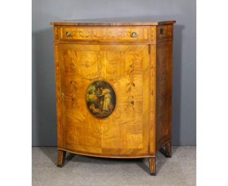 A 20th Century satinwood and kingwood bow-front commode of rococo design, inlaid with floral marquetry, with quartered matche