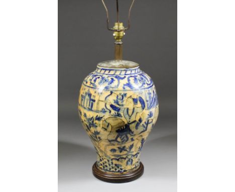 An Isnick blue and white pottery baluster shaped vase, painted with two huntsman on horseback, leopard and deer within a land