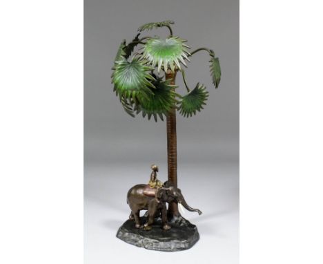 An early 20th Century Austrian cold painted bronze electric table lamp modelled in the form of an elephant and Mahout beneath