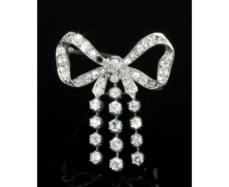 An early 20th Century silvery coloured metal all diamond set bow pattern brooch, the ribbon tied bow with three articulated h