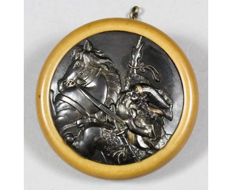 A Japanese Kagamibuta netsuke, the boxwood bowl with dark metal plate cast with a mounted Samurai, 1.875ins (48mm) diameter