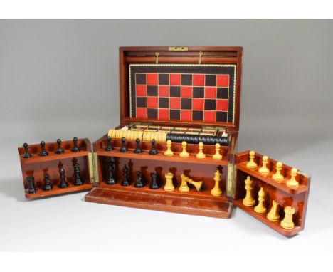 An early 20th Century mahogany cased games compendium with folding leather for Backgammon and Steeple Chase Game, and turned 