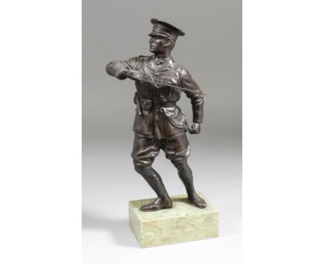 An Early 20th Century bronze figure of a First World War soldier in uniform brandishing a sword, 10.5ins high, on polished gr