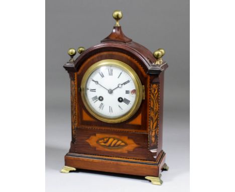 A late 19th Century inlaid mahogany cased mantel clock, the 4ins diameter enamel dial with Roman numerals to the French eight