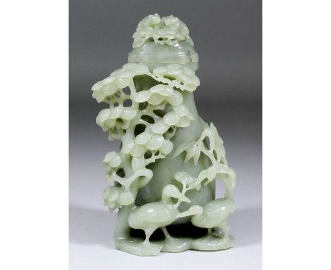 A Chinese grey/green jade baluster shaped vase and cover, the whole carved in relief with two small badgers on pinecones to c