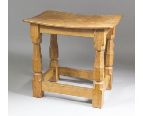 A Robert (Mouseman) Thompson of Kilburn dished topped oak stool, on octagonal baluster tapering supports joined by stretchers