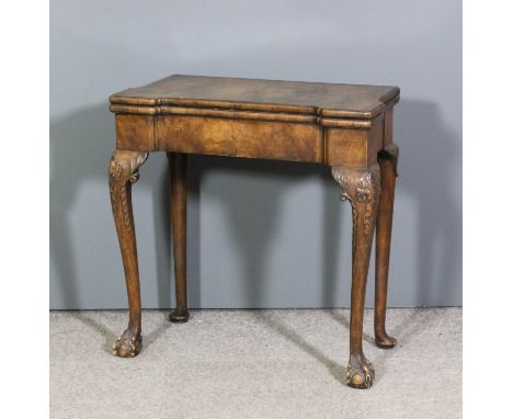 A good walnut rectangular card table of "Queen Anne" design with recessed front and sides, the top with matched veneer panels