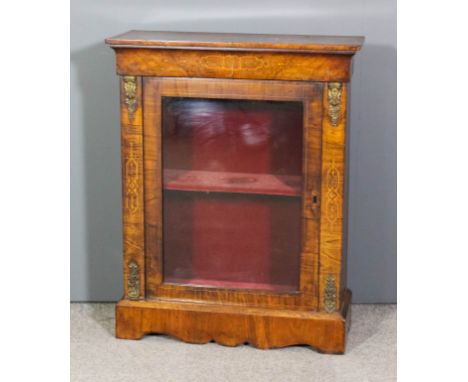 A Victorian gilt metal mounted figured walnut dwarf display cabinet, inlaid with boxwood stringings and marquetry, fitted sin