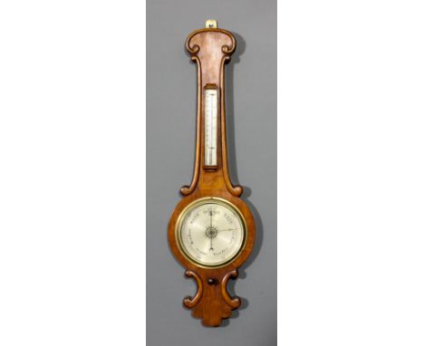 A Victorian oak cased wheel barometer and thermometer by Negretti & Zambra of London, with 8ins diameter silvered dial and al